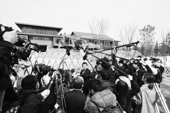 建設中の「瑞穂の國小学院」を視察した小池晃書記局長と殺到したメディア＝3月5日、豊中市内