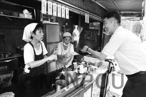 たこやき屋さんと対話する清水議員＝８月31日、大阪市北区内