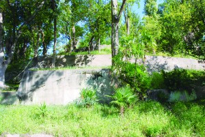 当時の通気口がいまも残る生玉公園の地下壕跡。近くには1996年設置の府・大阪市の銘板が。